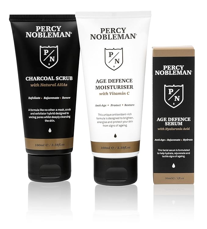 Age Defence Kit, a men's skincare set containing Charcoal Face Scrub (with Natural AHAs), ultra-hydrating Facial Serum (with Hyaluronic Acid), and Moisturiser (with Vitamin C)
